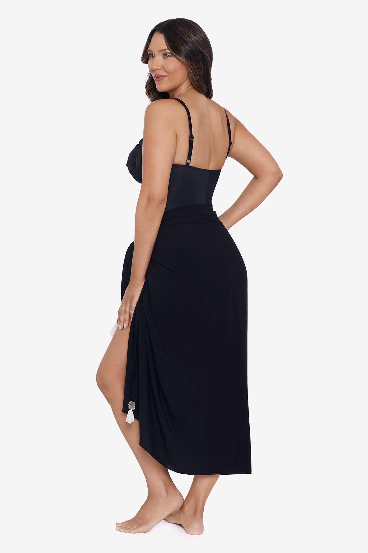 Woman faced left wearing a black swim wrap cover up with tassels