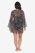 Woman faced away wearing an animal printed sheer swim cover up