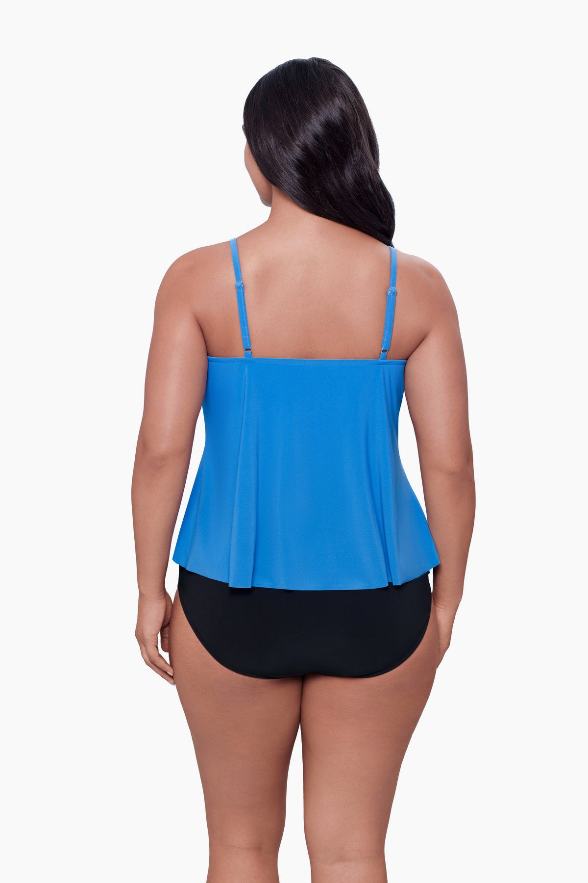 Woman turned away wearing a tiered tankini top in light blue