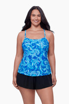 Woman wearing a swim romper with a blue abstract print
