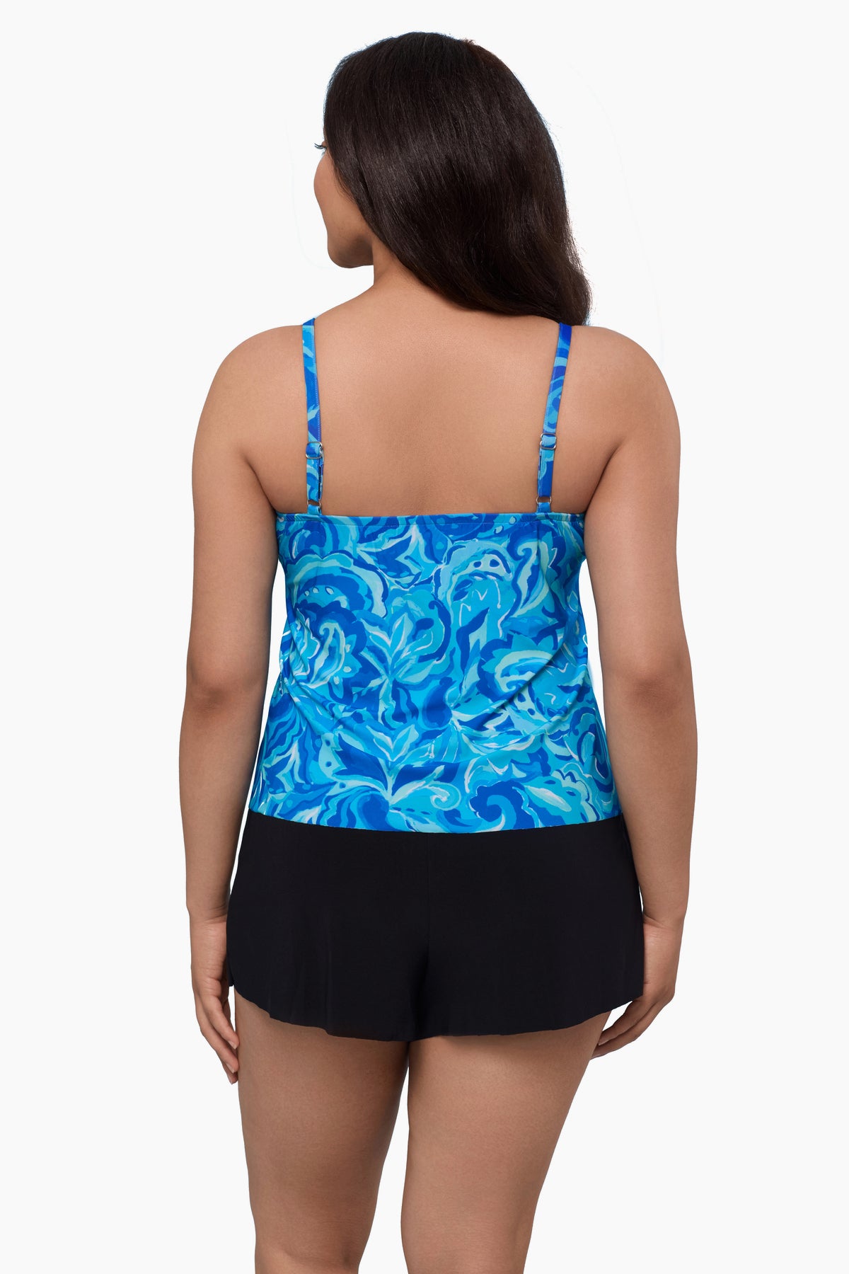 Woman turned away wearing a swim romper with an abstract blue print