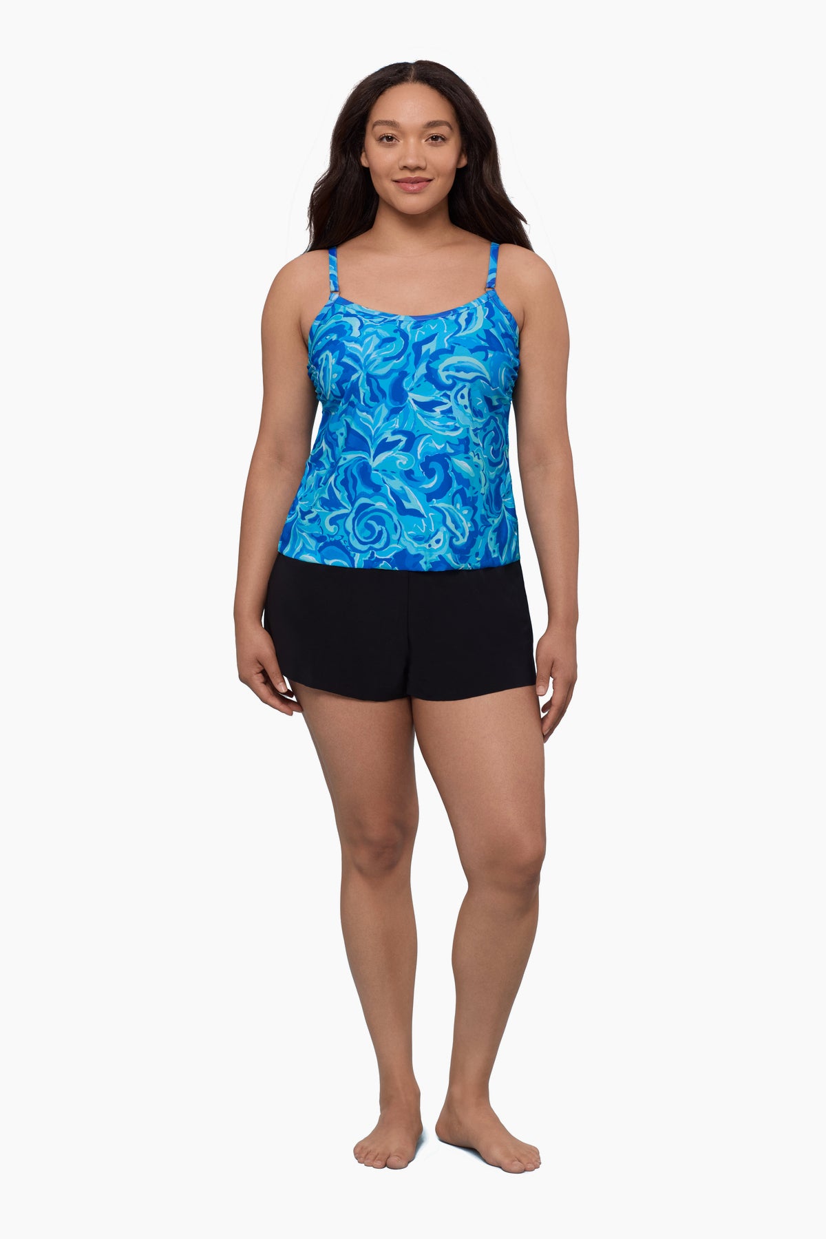 Woman wearing a swim romper with an abstract blue print