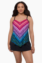 Woman wearing a tankini top with a multicolored geometric print