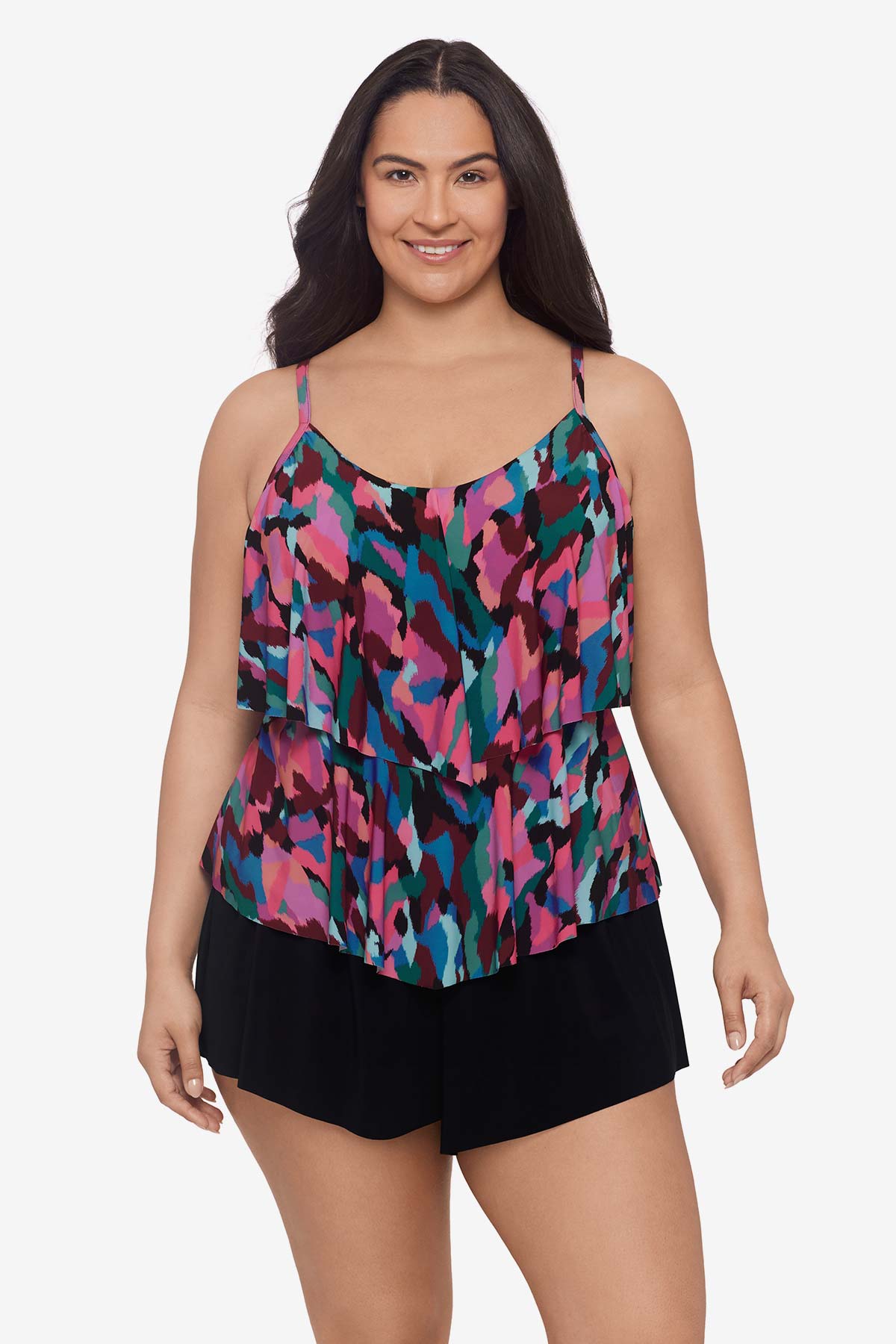 Woman wearing a multicolored abstract collage printed tankini top with ruffles