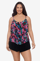 Woman wearing a multicolored abstract collage printed tankini top with ruffles