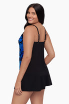 Woman turned left wearing a tankini top with a blue floral pattern