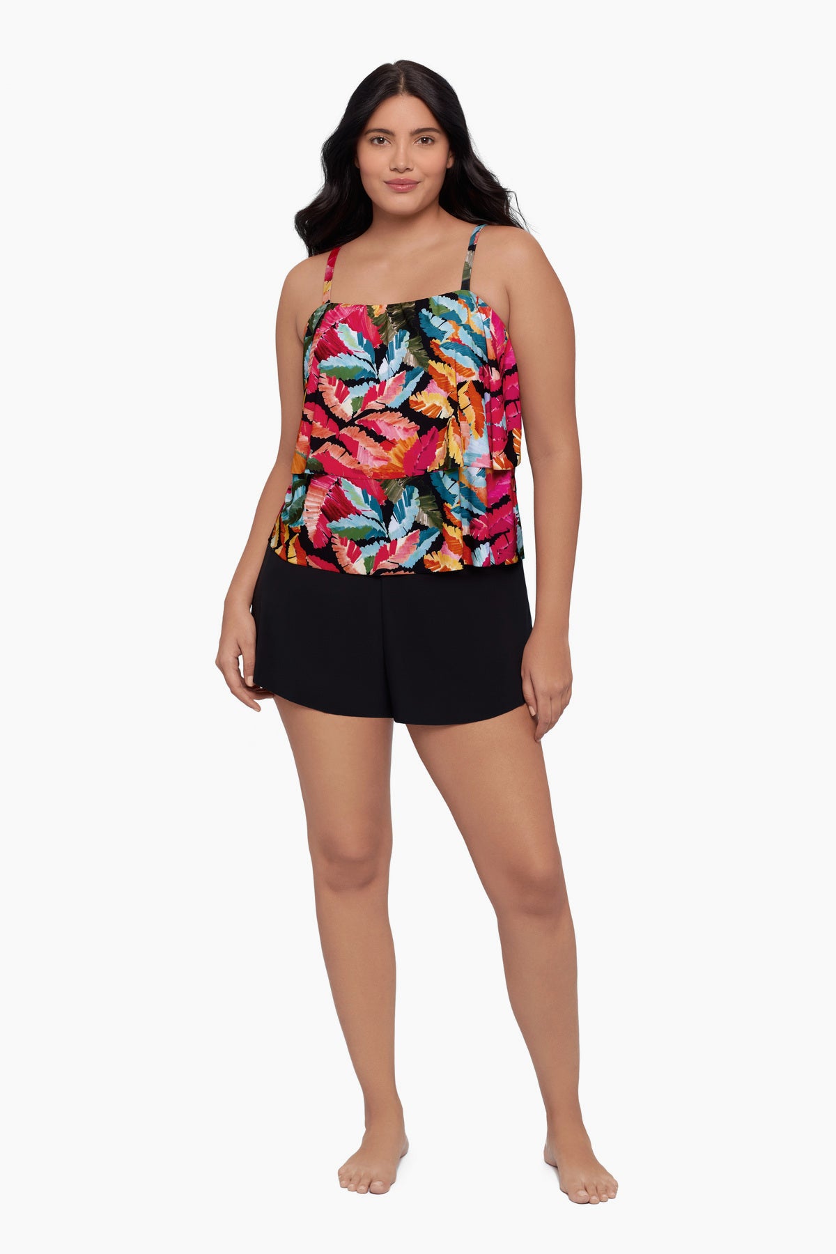 Woman wearing a swim romper with a bright multicolored floral pattern