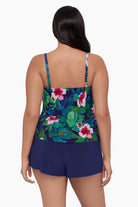 Woman turned away wearing a swim romper with a floral print