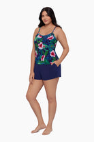 Woman wearing a swim romper with a floral print with her hand in pocket