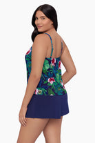 Woman turned left wearing a swim romper with a floral print