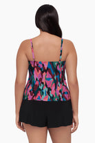 Woman turned away wearing a swim romper with a collage patchwork print