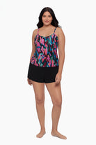 Woman wearing a swim romper with a collage patchwork patter