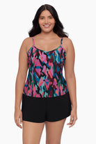 Woman wearing a swim romper with a collage patchwork pattern