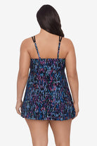 Woman faced away wearing a blue and purple abstract printed swim dress