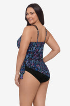 Woman faced left wearing a blue and purple abstract printed swim dress