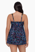 Woman turned away wearing a swim dress with a blue abstract pattern