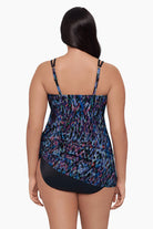 Woman turned away wearing a swim dress with a blue abstract pattern