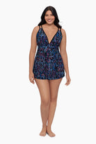 Woman wearing a swim dress with a blue abstract pattern