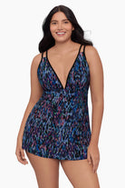 Woman wearing a swim dress with a blue abstract pattern
