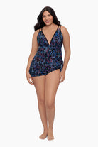 Woman wearing a swim dress with a blue abstract pattern
