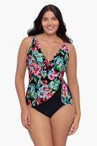 Woman wearing a one-piece swimsuit with a floral print