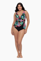 Woman wearing a one-piece swimsuit with a floral print