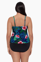 Woman turned away wearing a tankini top with a floral pattern