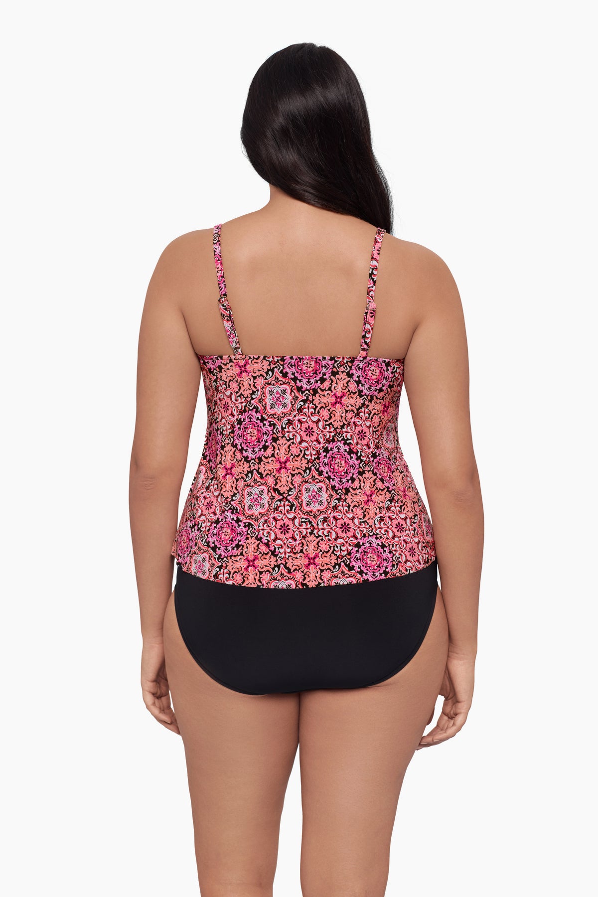 Woman turned away wearing a tankini top with a pink tile pattern