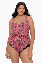 Woman wearing a tiered tankini top with a pink tile pattern