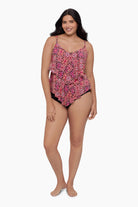 Woman wearing a tiered tankini top with a pink tile pattern