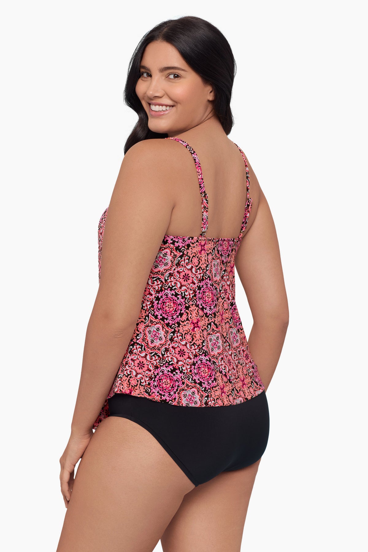 Woman turned left wearing a tiered tankini top with a pink tile pattern