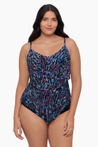 Woman wearing a tiered tankini top with a blue abstract print