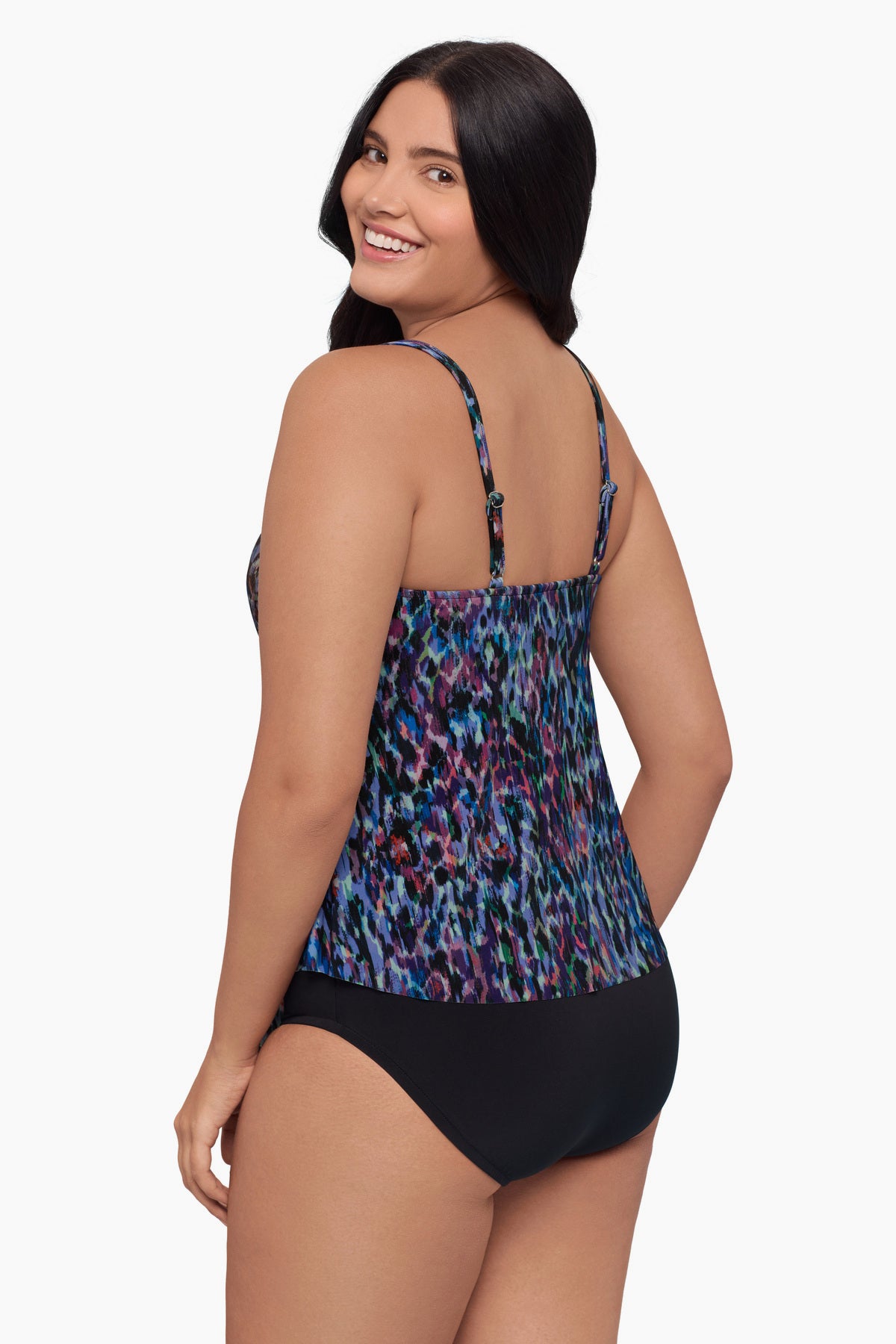 Woman turned left wearing a tiered tankini top with a blue abstract print