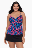 Woman wearing a tankini top with a pink and blue pattern