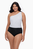 Woman wearing a one-piece swimsuit with an asymmetrical cut