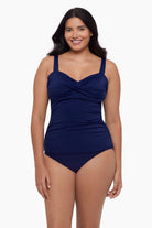 Woman wearing a tankini top in ink blue