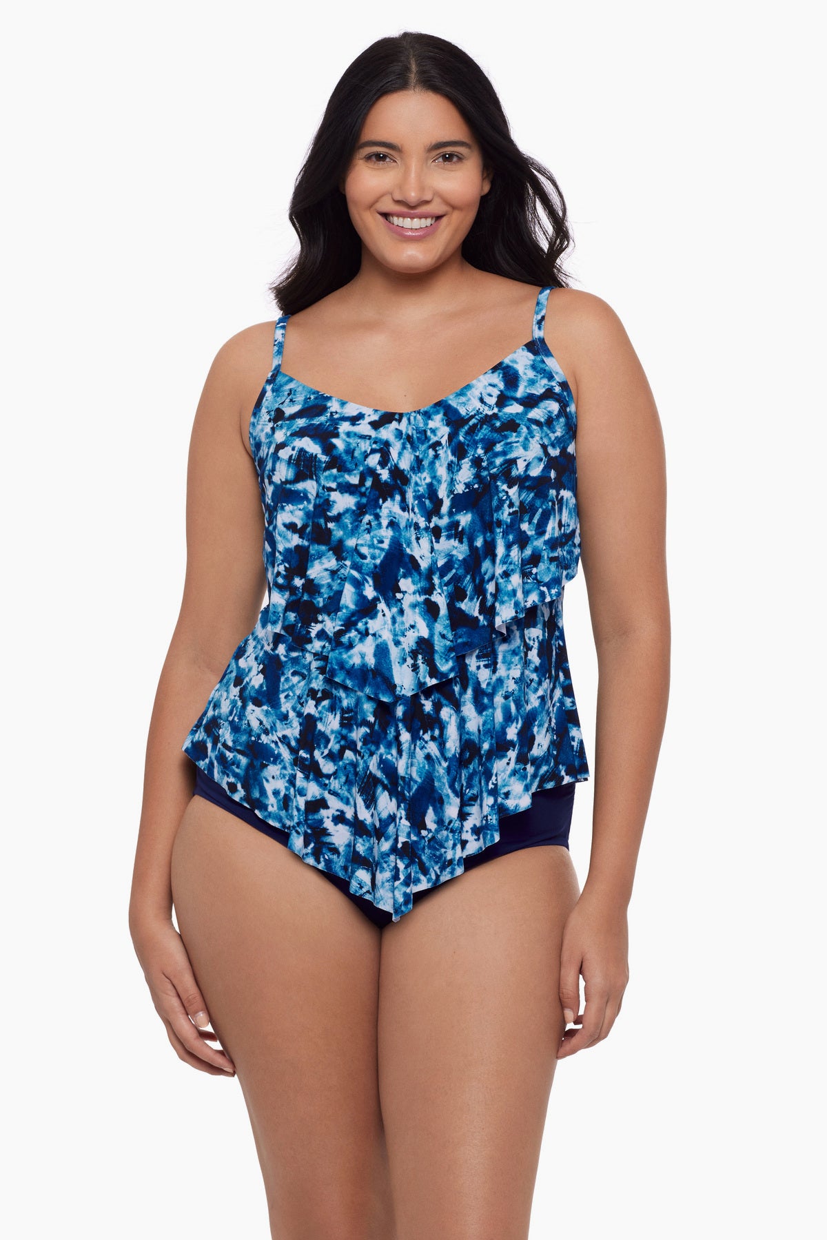 Woman wearing a tiered tankini top with a blue tie dye print