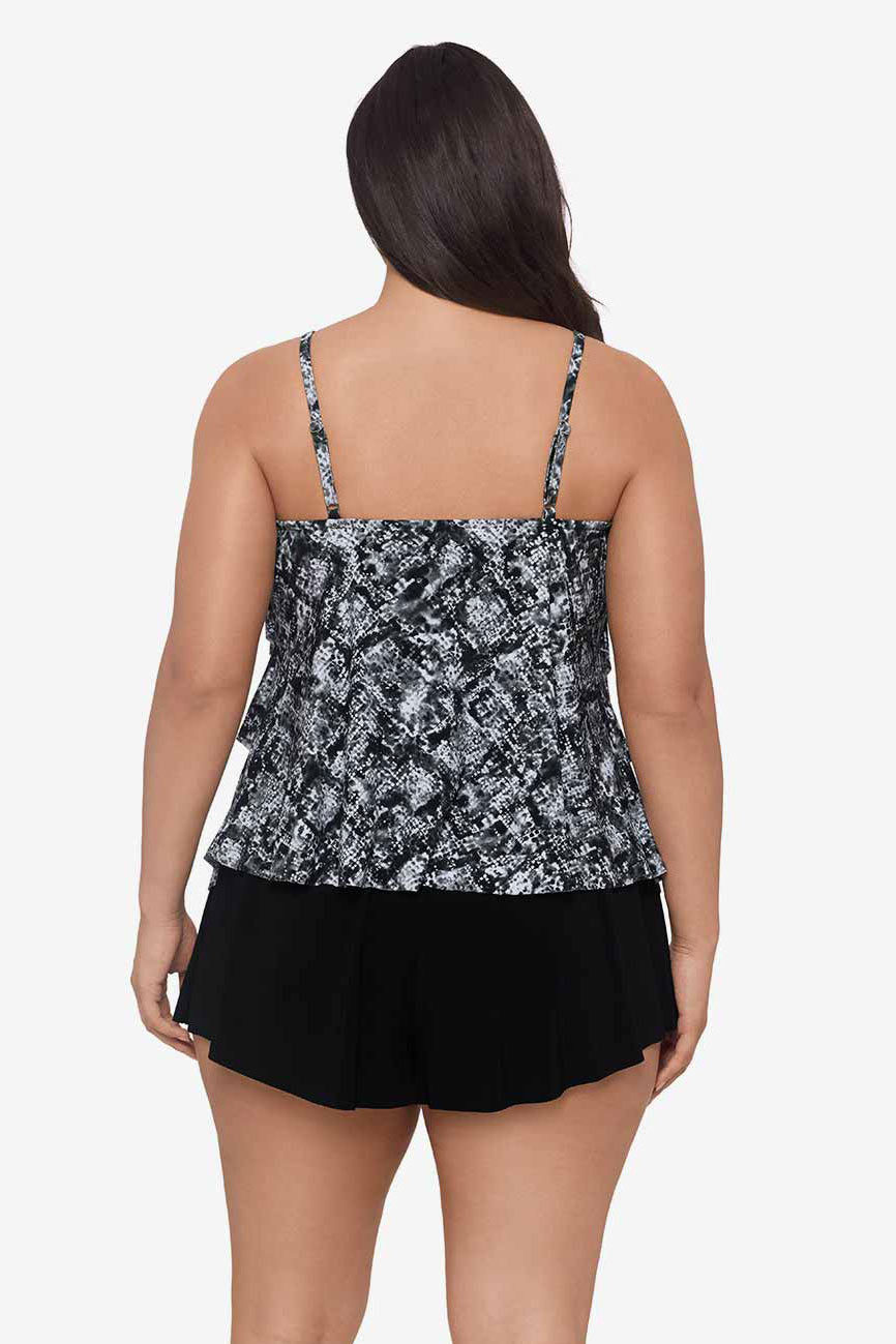 Woman faced away wearing a black and white misty printed tankini top with ruffles