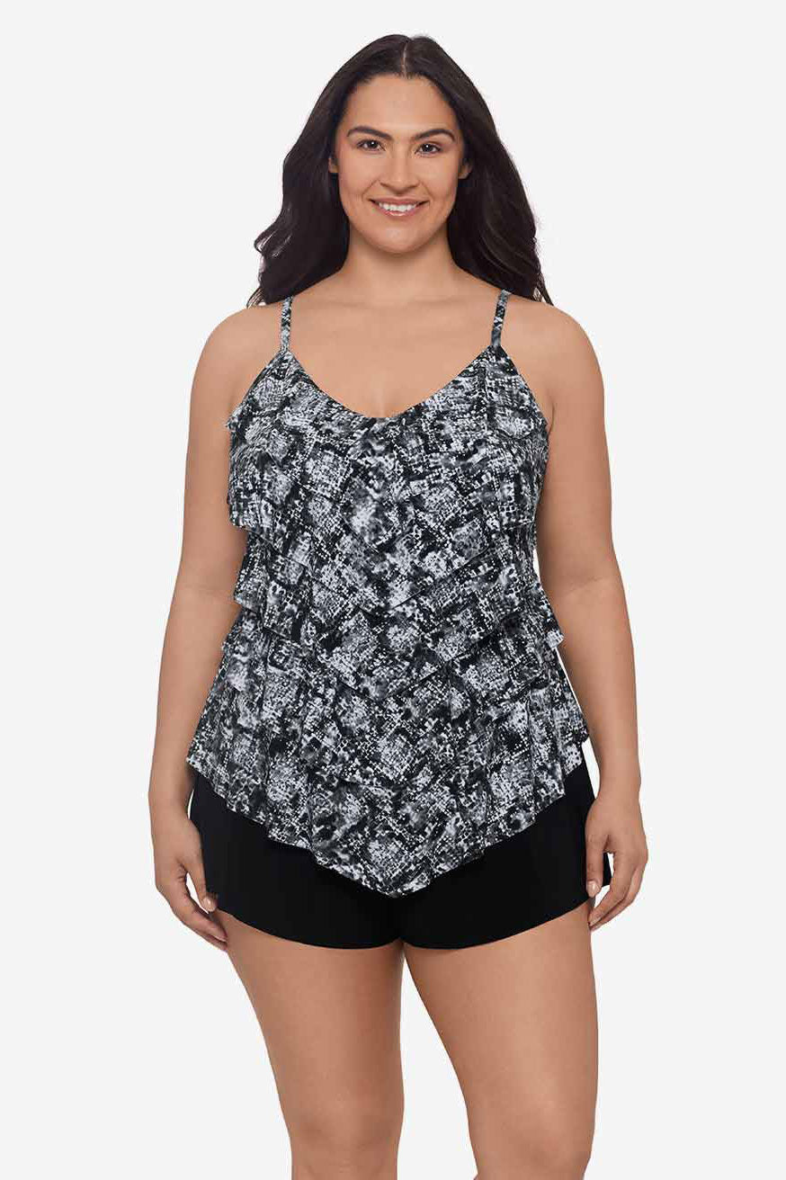 Woman wearing a black and white misty printed tankini top with ruffles