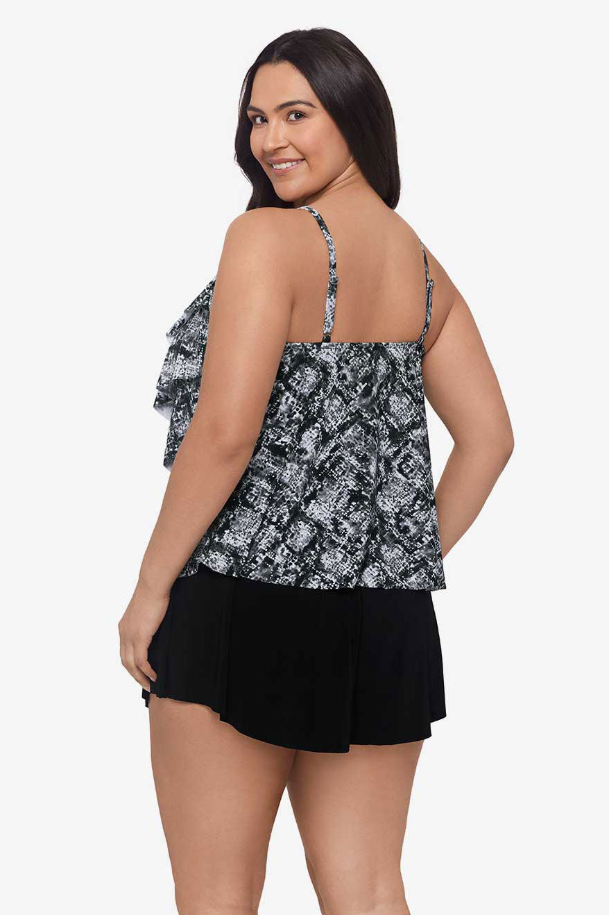 Woman turned left wearing a black and white misty printed tankini top with ruffles