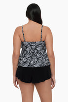 Woman turned away wearing a tiered tankini top with a black and white print