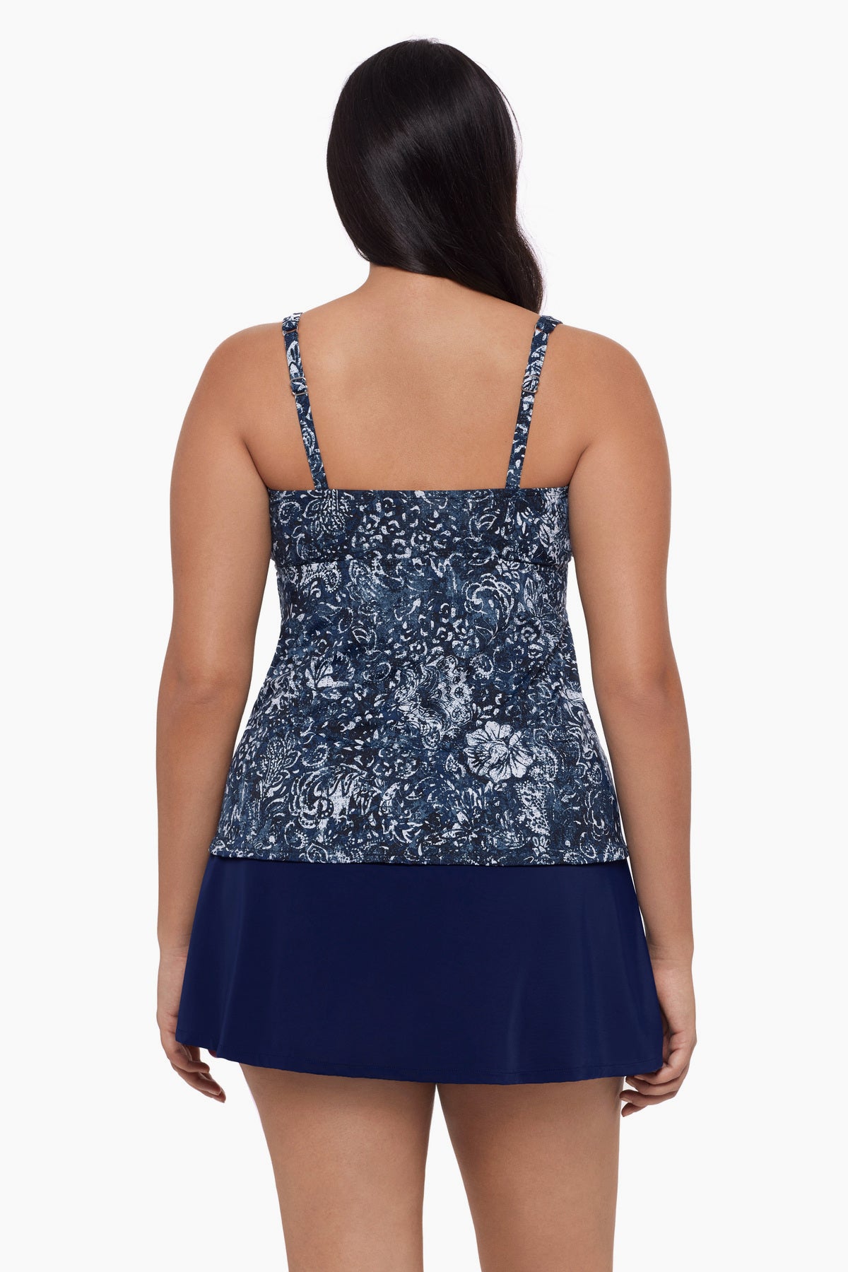 Woman turned away wearing a tankini top with a paisley-esque print