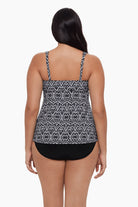 Woman turned away wearing a tankini top with a black and white pattern