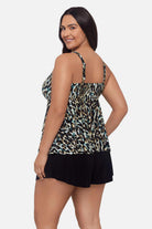 Woman turned left wearing animal print tankini top with ruffles