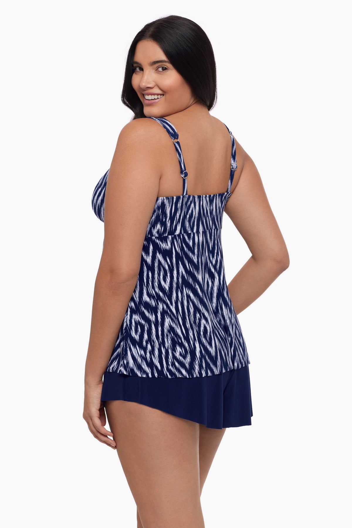 Woman turned left  wearing a tankini top with an abstract blue and white print
