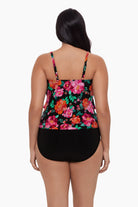 Woman turned away wearing a tankini top with a red and pink floral pattern