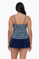 Woman turned away wearing a tankini top with a blue tile print
