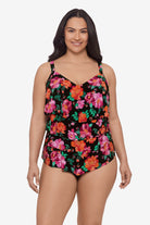Woman wearing a pink and orange floral printed tankini top with ruffles