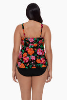 Woman turned away wearing a red and pink floral printed tankini top