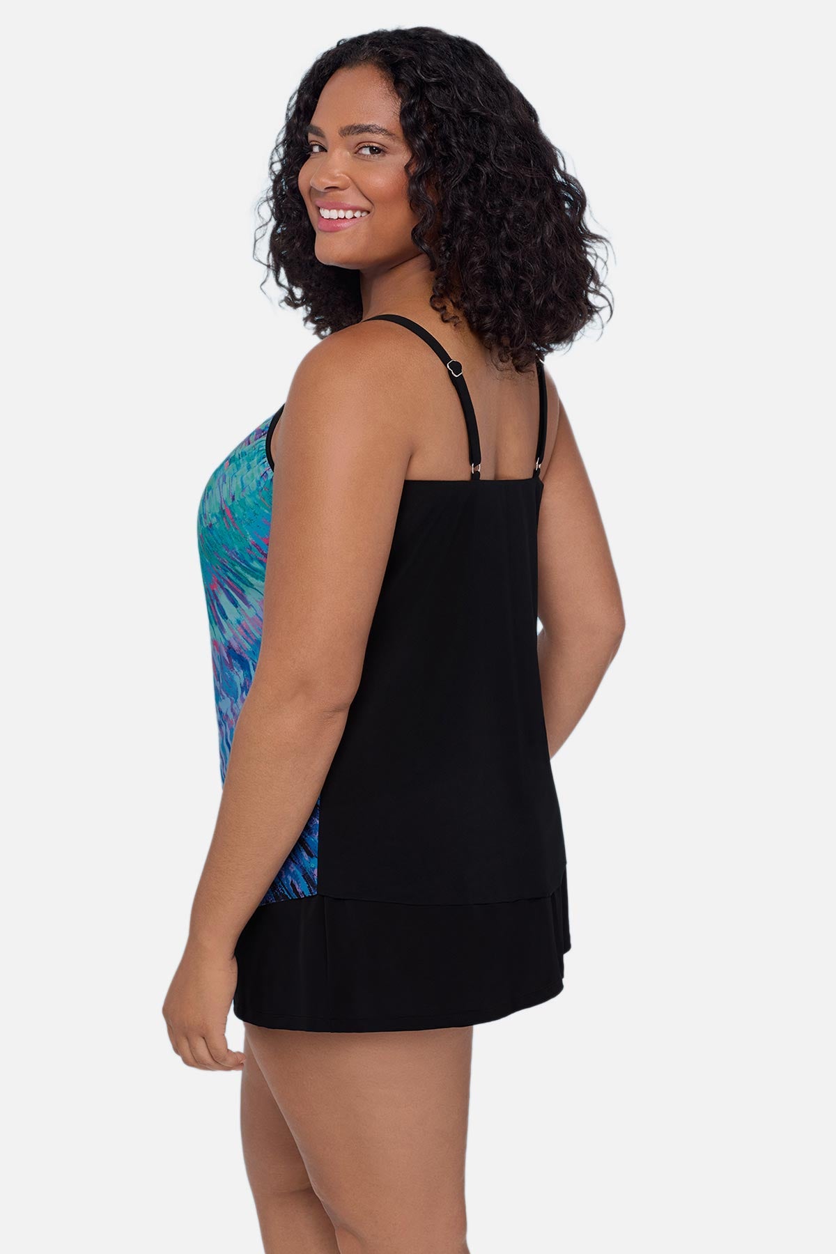 Woman turned left wearing a blue tie dye tankini top 